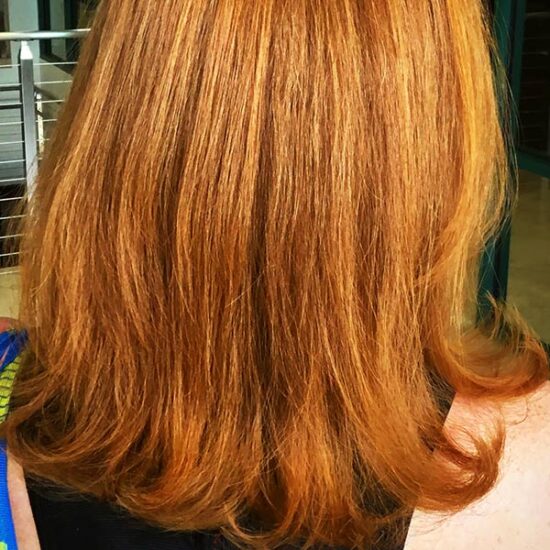 red hair coloring on woman at the salon